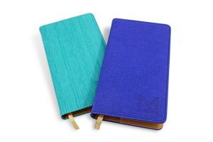 Pocket notepad with different material covers