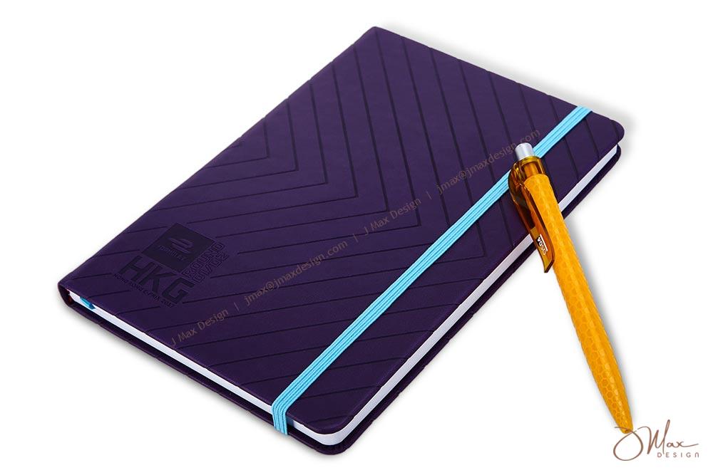 Hard cover notepad in purple with blue elastic band