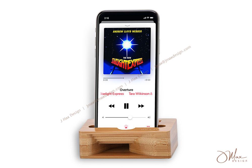A cell phone is placed in a bamboo amplifier