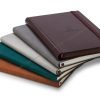 Stacked notepads in different material covers