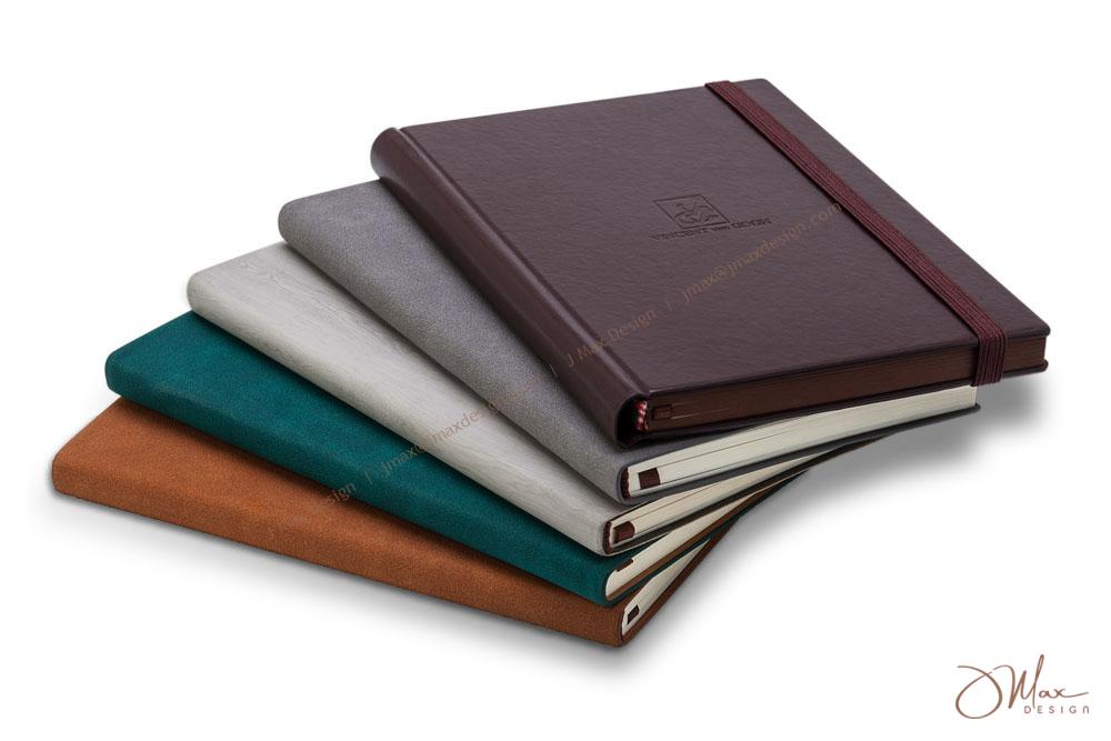 Notepads in different covers material and colors Stacked notepads in different material covers