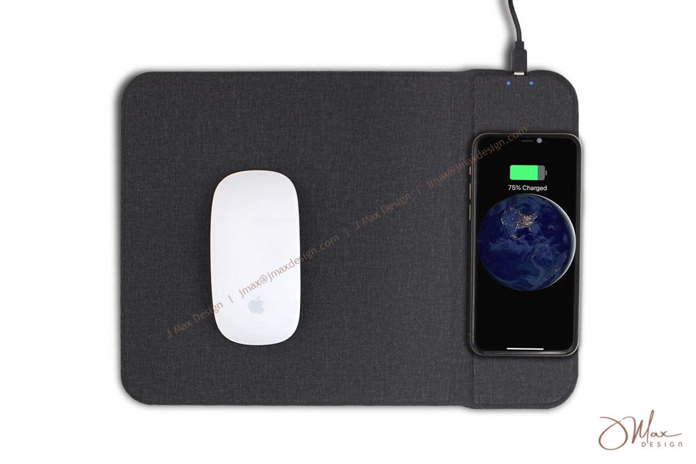 magic and cell phone on charging mouse pad a cell phone is charging on a flat mouse pad