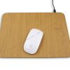 Magic mouse on a wooden-patterned mousepad