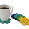 Coffee mug on felt coaster and coasters in different colors