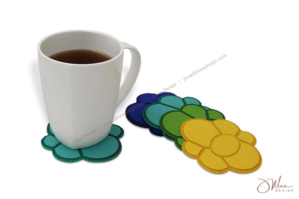 Coffee mug on felt coaster and coasters in different colors