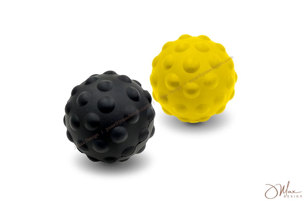A black and a yellow massage ball with textured surfaces, designed for muscle relief and recovery, displayed on a white background.